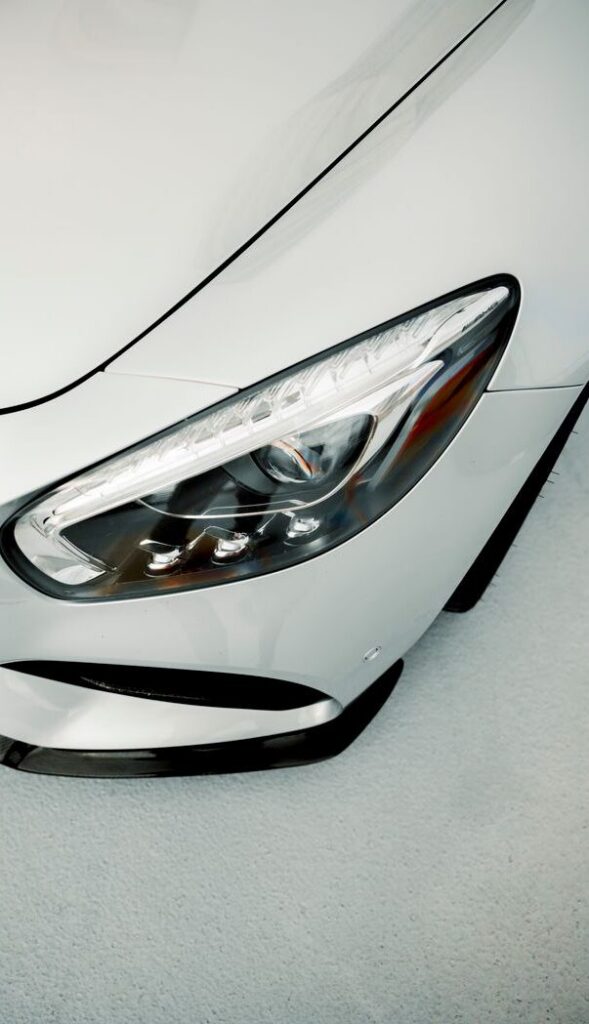 Close-up shot of a luxury car's sleek headlight showing modern design.